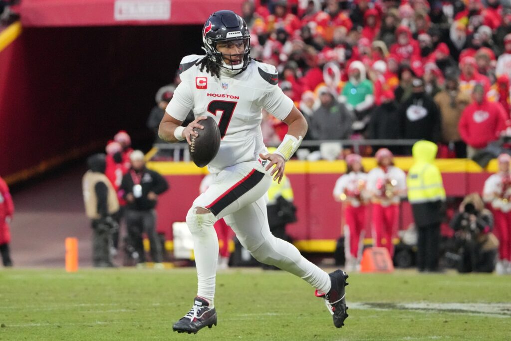 Jan 18, 2025; Kansas City, Missouri, USA; Houston Texans quarterback C.J. Stroud (7) rolls out to throw against the Kansas City Chiefs during the third quarter of a 2025 AFC divisional round game at GEHA Field at Arrowhead Stadium. Mandatory Credit: Denny Medley-Imagn Images