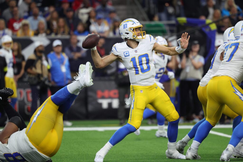 Jan 11, 2025; Houston, Texas, USA; Los Angeles Chargers quarterback Justin Herbert (10) looks to pass during the second quarter against the Houston Texans in an AFC wild card game at NRG Stadium. Mandatory Credit: Troy Taormina-Imagn Images